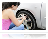 Woman refilling air in her car tyre, Calgary AB